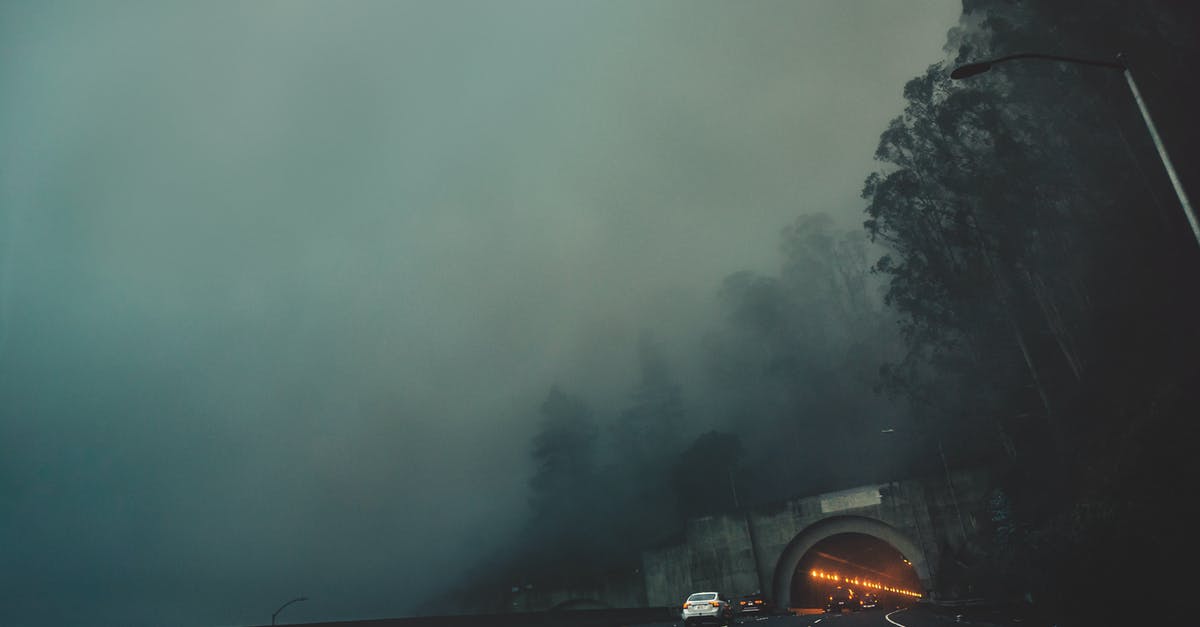 I drive from Channel Tunnel Calais to Kempten in Germany on 18.06.19 what would be the quickest route [closed] - Cars riding along asphalt road towards tunnel on gloomy weather