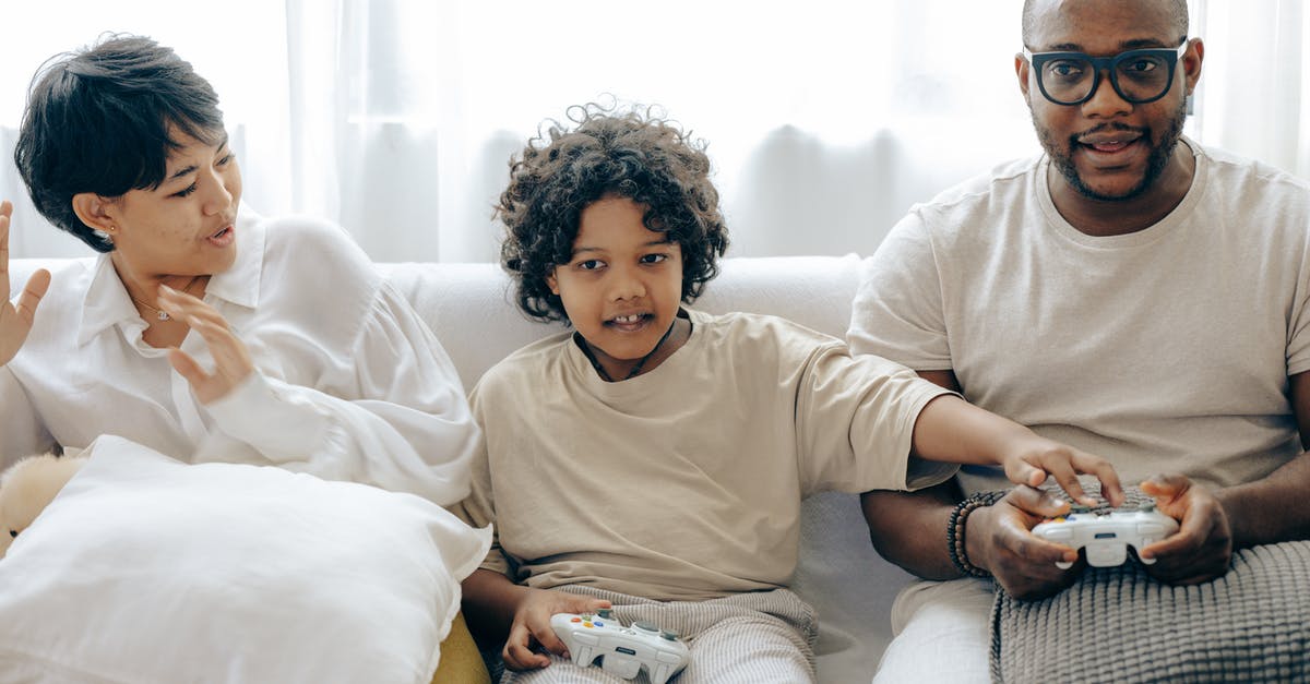 I have a B2 visa. Can I make a stop over in the US without using my B2 visa [closed] - Interested ethnic kid preventing father from winning in video game while resting together with mother in living room