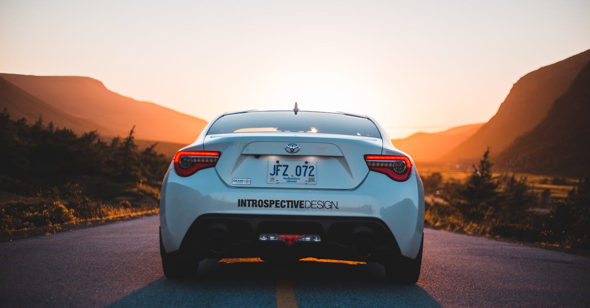 I have a one way ticket to Austria, will they send me back home? - Back part of modern white automobile on paved highway road in mountains glowing with sunset light I have a one way ticket to Austria, will they send me back home? - Back part of modern white automobile on paved highway road in mountains glowing with sunset light