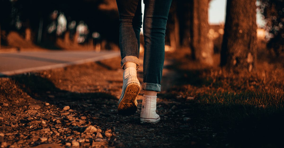 I have multiple Schengen visa from Italy, can I transit in Holland for 2 hours before going to Italy? [duplicate] - Person in Blue Jeans and White Sneakers Walking on the Ground
