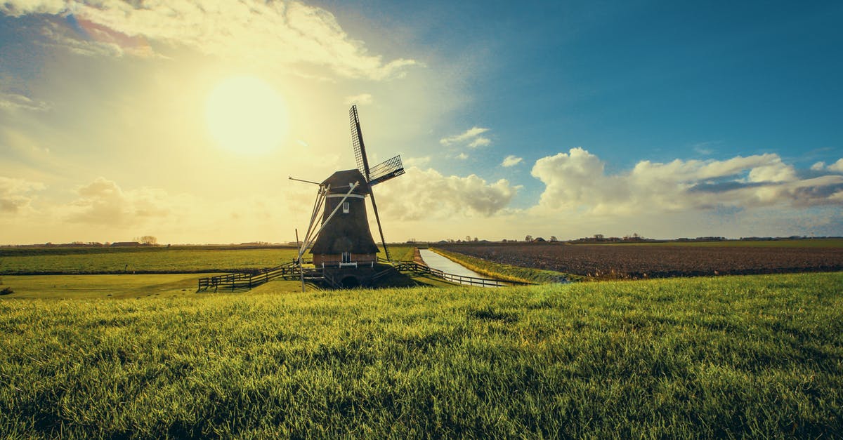 I have multiple Schengen visa from Italy, can I transit in Holland for 2 hours before going to Italy? [duplicate] - Vintage Black Windmill during Sunset