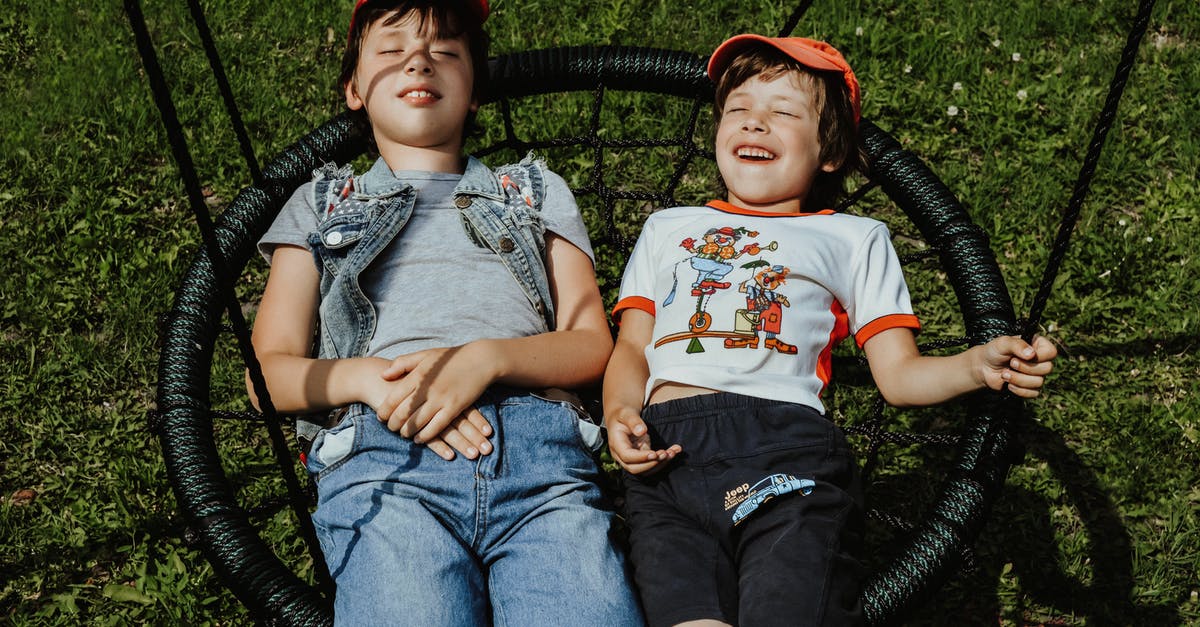 I have to attend UCLH coming from Hitchin. Which is quickest, St Pancras to Warren St Stan or Finsbury Park on Northern line? [closed] - From above of happy boys with closed eyes wearing caps lying on round swing on grassy lawn while having fun in yard