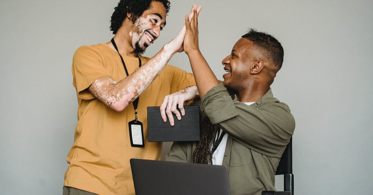 I have two passports with different names in each. Which name should I use for booking my ticket? [duplicate] - Positive black colleagues giving high five