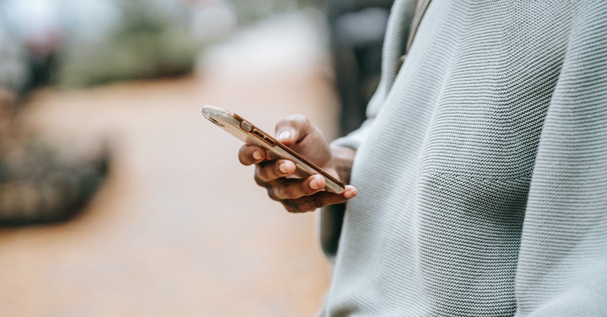 I received a non straightforward email regarding my UK Visa application - Crop ethnic woman with mobile phone I received a non straightforward email regarding my UK Visa application - Crop ethnic woman with mobile phone