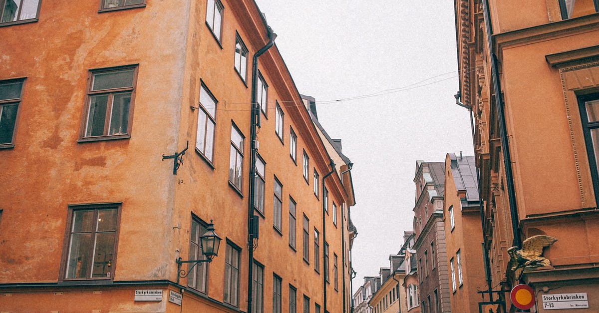 I want to travel out off schengen area with visa d germany? - From below of aged residential red buildings on narrow curve street in old city centre I want to travel out off schengen area with visa d germany? - From below of aged residential red buildings on narrow curve street in old city centre