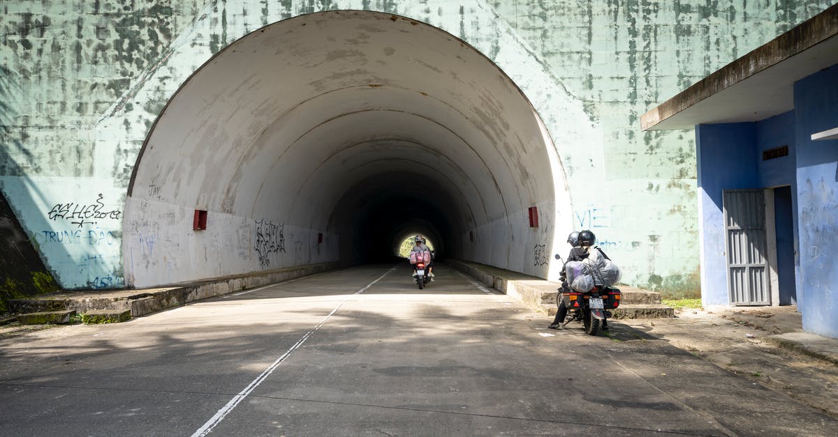 I want to travel out off schengen area with visa d germany? - People riding motorbikes on straight asphalt roadway leading to shabby tunnel near old building in suburb area of sunny countryside I want to travel out off schengen area with visa d germany? - People riding motorbikes on straight asphalt roadway leading to shabby tunnel near old building in suburb area of sunny countryside