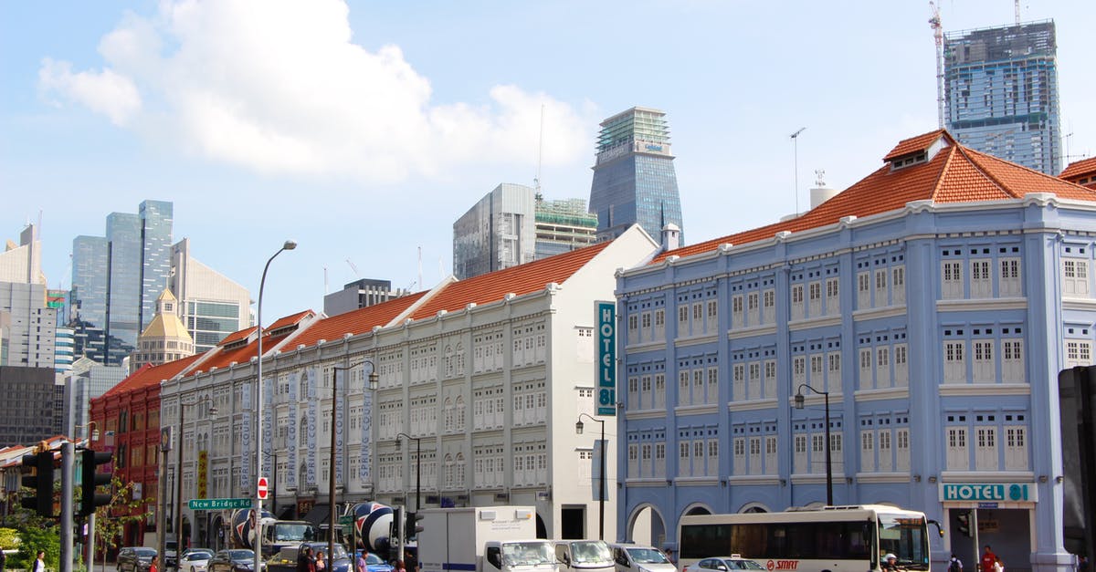 ICA Refused entry to Singapore [duplicate] - A Moving Cars on the Road Near the City Buildings