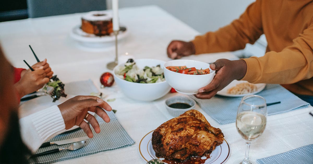 Iceland over Christmas period - Crop black relatives at served table with Christmas meal