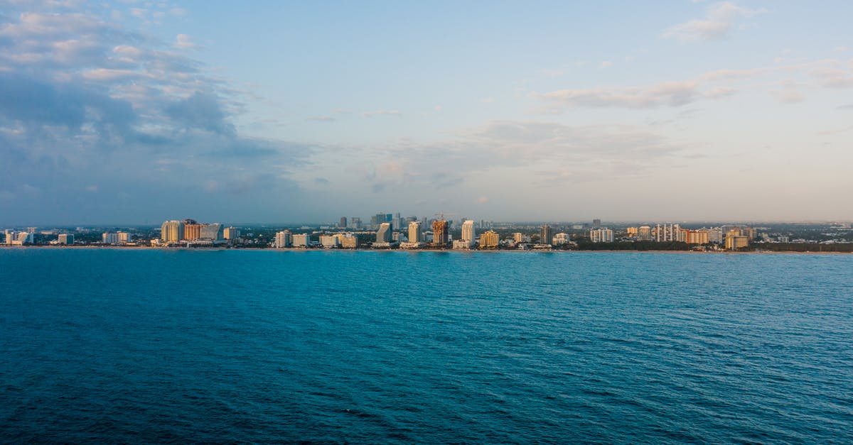 Identify waterside building / skyline - Modern city district with multistage buildings near sea Identify waterside building / skyline - Modern city district with multistage buildings near sea