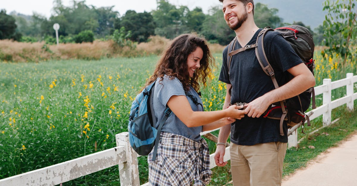 If I have a 5 hour layover in Frankfurt, how much time do I have to explore the city? (Quick) [duplicate] - Happy woman fastening backpack strap of boyfriend near meadow