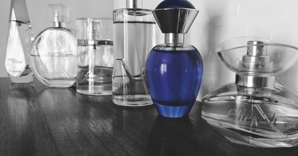 if i have a 5oz container of cologne (liquid), but it is only 15ml, will i be able to take it on the plane? [duplicate] - Selective Focus Photography of Blue Fragrance Bottles on Table