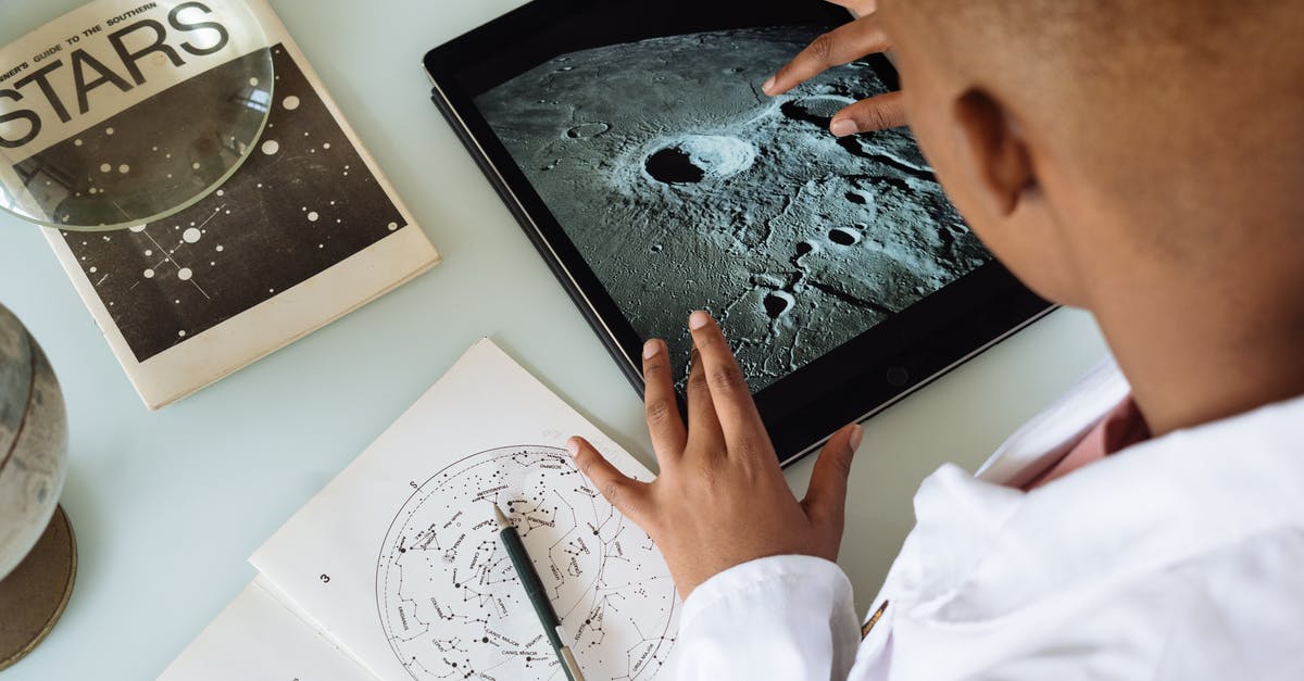 Ijen crater and batu secret zoo from Surabaya - Crop African American student studying craters of moon on tablet at observatory Ijen crater and batu secret zoo from Surabaya - Crop African American student studying craters of moon on tablet at observatory