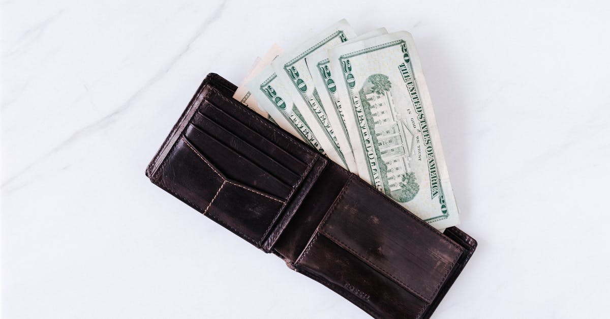 Importing a kangaroo scrotum wallet to the United States - From above of black leather wallet with pockets filled with heap of dollar banknotes on white table Importing a kangaroo scrotum wallet to the United States - From above of black leather wallet with pockets filled with heap of dollar banknotes on white table