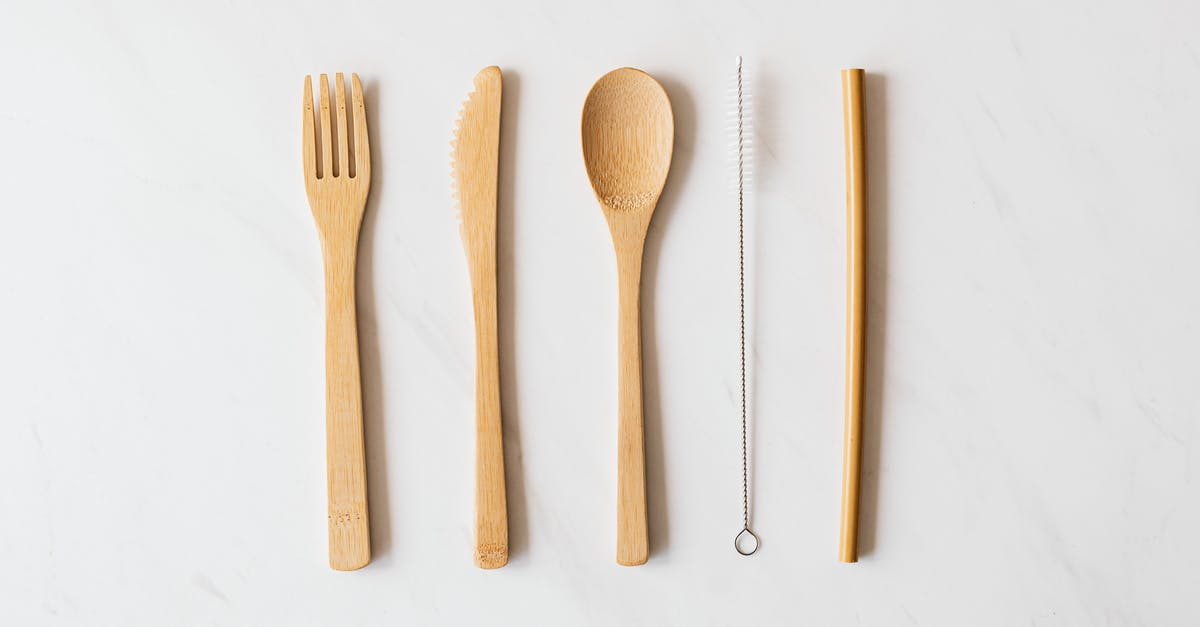 Importing silverware utensil sets to Hong Kong - Wooden cutlery and tube with brush on marble table Importing silverware utensil sets to Hong Kong - Wooden cutlery and tube with brush on marble table