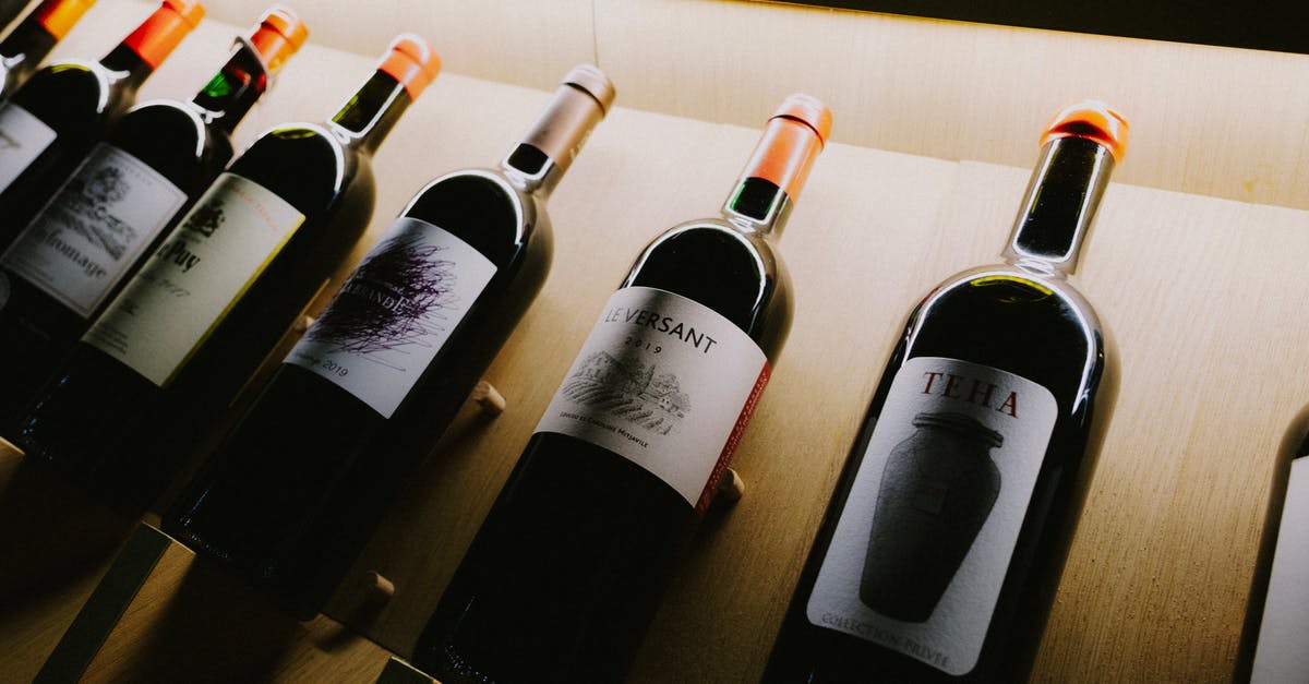 In Belarus, do norms for a work event include informal bar drinks and snacks in the evening? [closed] - Wine Bottles on Brown Wooden Shelf