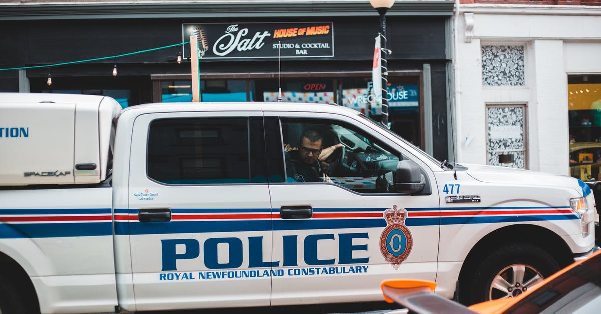 In countries with a "Keep right/left unless overtaking" rule: May I keep the left/right lane if driving at speed limit? [closed] - Policeman sitting in police car driving on street
