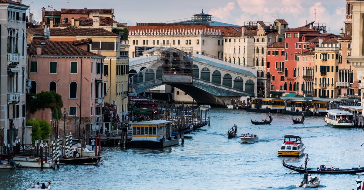 In Europe, where is a water border with visible markers, which can be crossed by a tourist in a small rented boat, without a passport check? - White High Raise Building