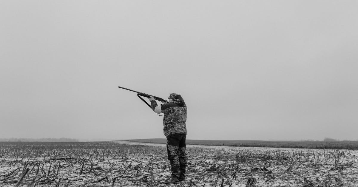 In Poland, is/are there any region dangerous for non-white people to visit? - Monochrome Photo of a Man Aiming His Firearm In Poland, is/are there any region dangerous for non-white people to visit? - Monochrome Photo of a Man Aiming His Firearm