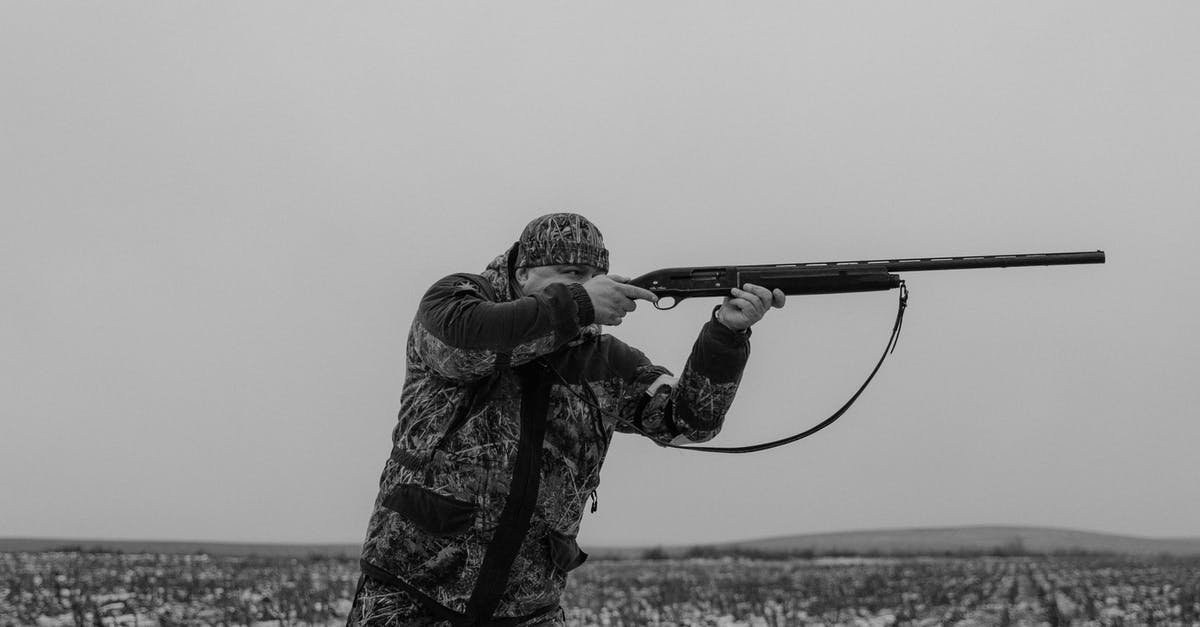 In Poland, is/are there any region dangerous for non-white people to visit? - Monochrome Photo of a Hunter Aiming His Gun In Poland, is/are there any region dangerous for non-white people to visit? - Monochrome Photo of a Hunter Aiming His Gun