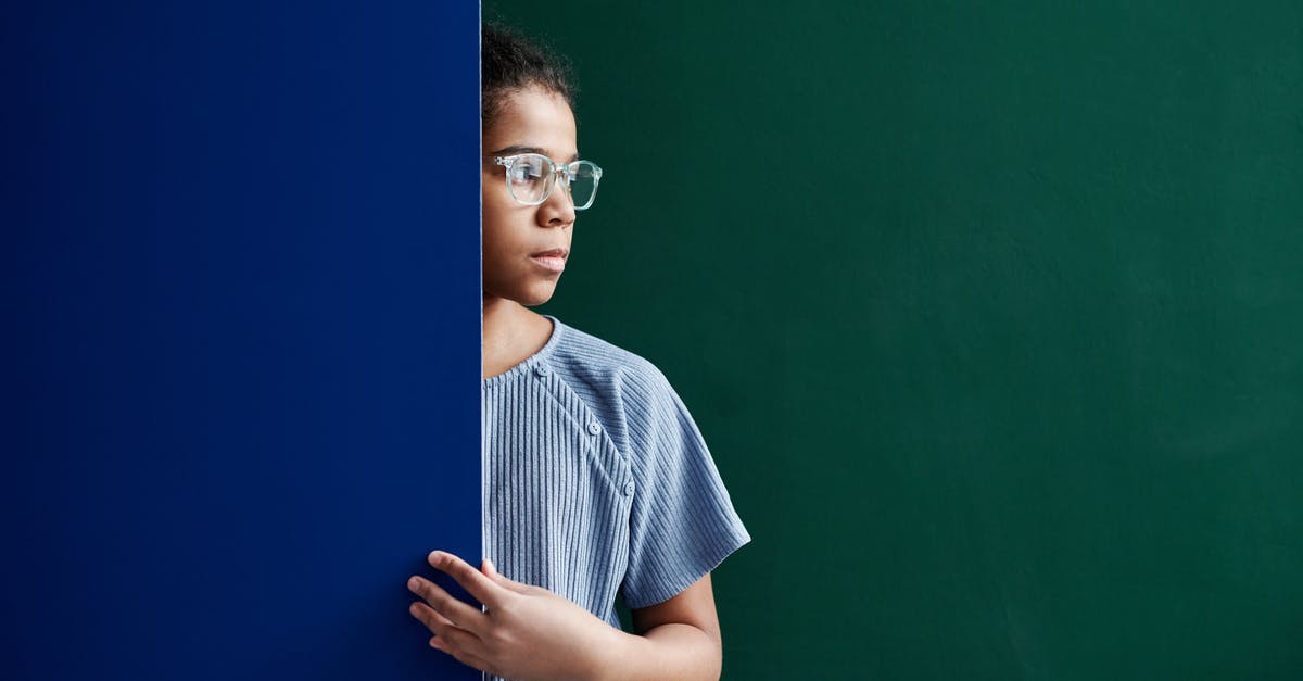 In practice, what is the distinction between ESTA and visas? - A Woman in Blue Shirt Standing Between Green and Blue Wall In practice, what is the distinction between ESTA and visas? - A Woman in Blue Shirt Standing Between Green and Blue Wall