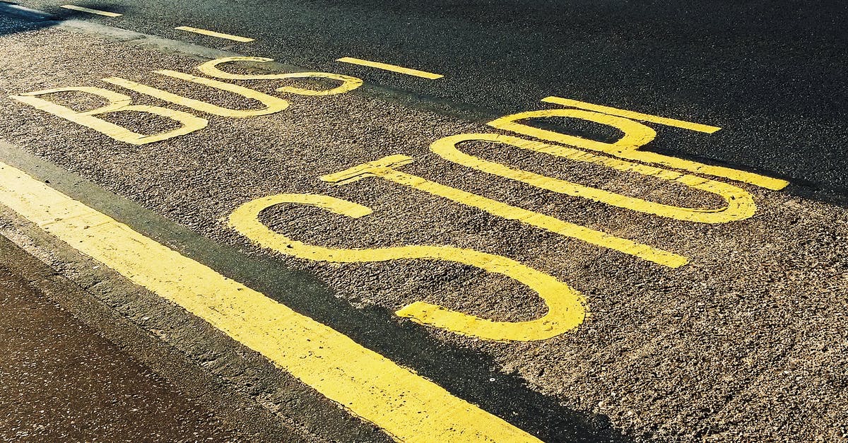 In Rio de Janeiro, which lane should I be using when biking and there's a bus-only lane? - Bus Stop Printed on Asphalt Road In Rio de Janeiro, which lane should I be using when biking and there's a bus-only lane? - Bus Stop Printed on Asphalt Road