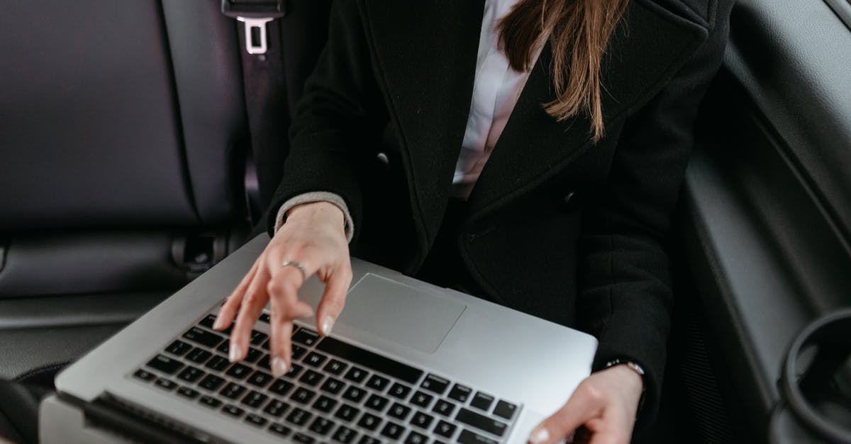 In Singapore, how much does an average person use a car? [closed] - Woman in Black Blazer Using Laptop Inside the Car 