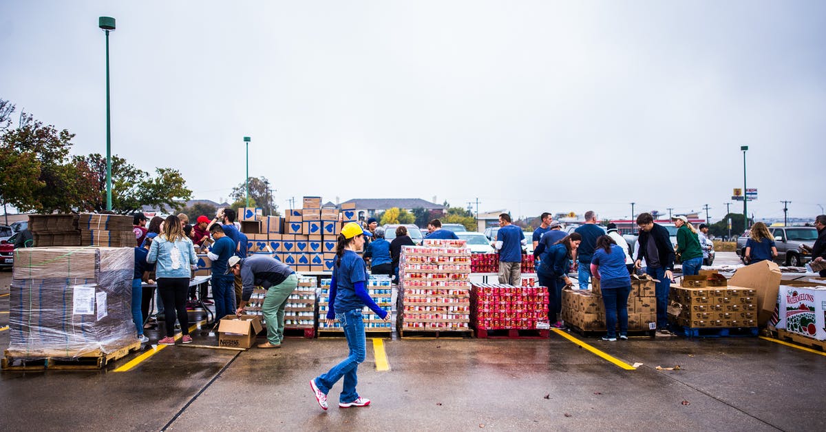In Transit - Value of Goods - Full body of young female employee of terminal port coming to delivered containers of cargo In Transit - Value of Goods - Full body of young female employee of terminal port coming to delivered containers of cargo
