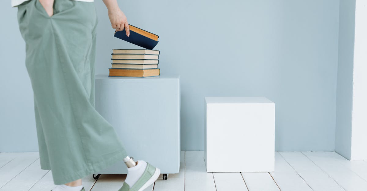 In Visa, "+" has been put in place of surname - Woman in Green Dress Holding Books In Visa, "+" has been put in place of surname - Woman in Green Dress Holding Books