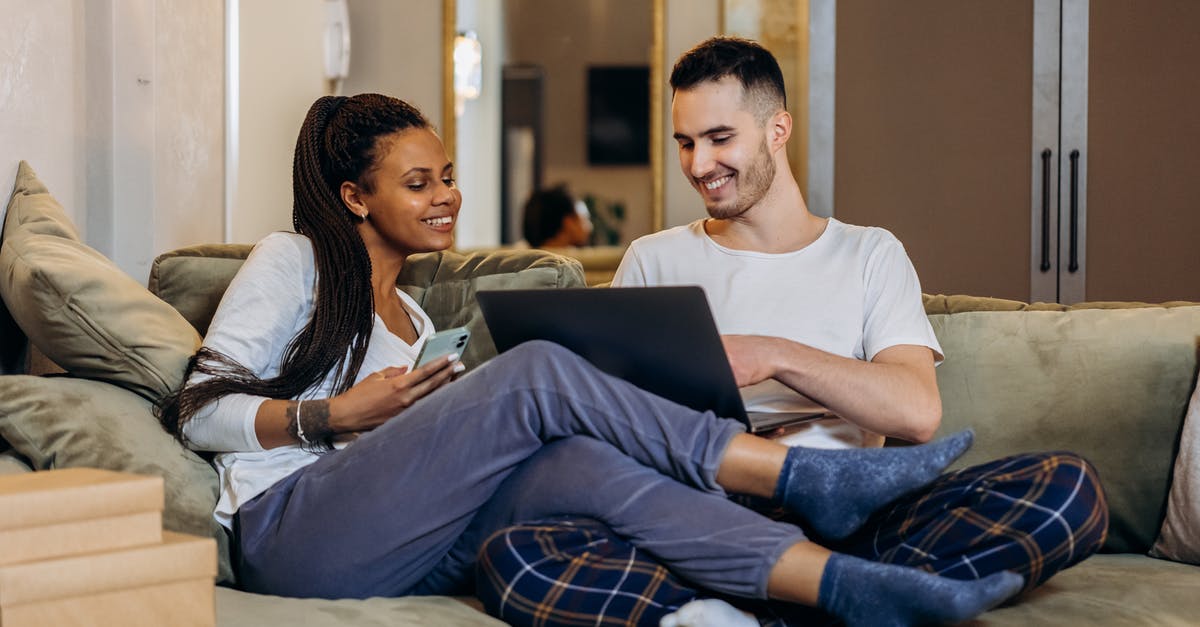 In which bag laptop charger and laptop battery can be taken? And in which bag food can be taken? [closed] - Man and Woman Sitting on Couch