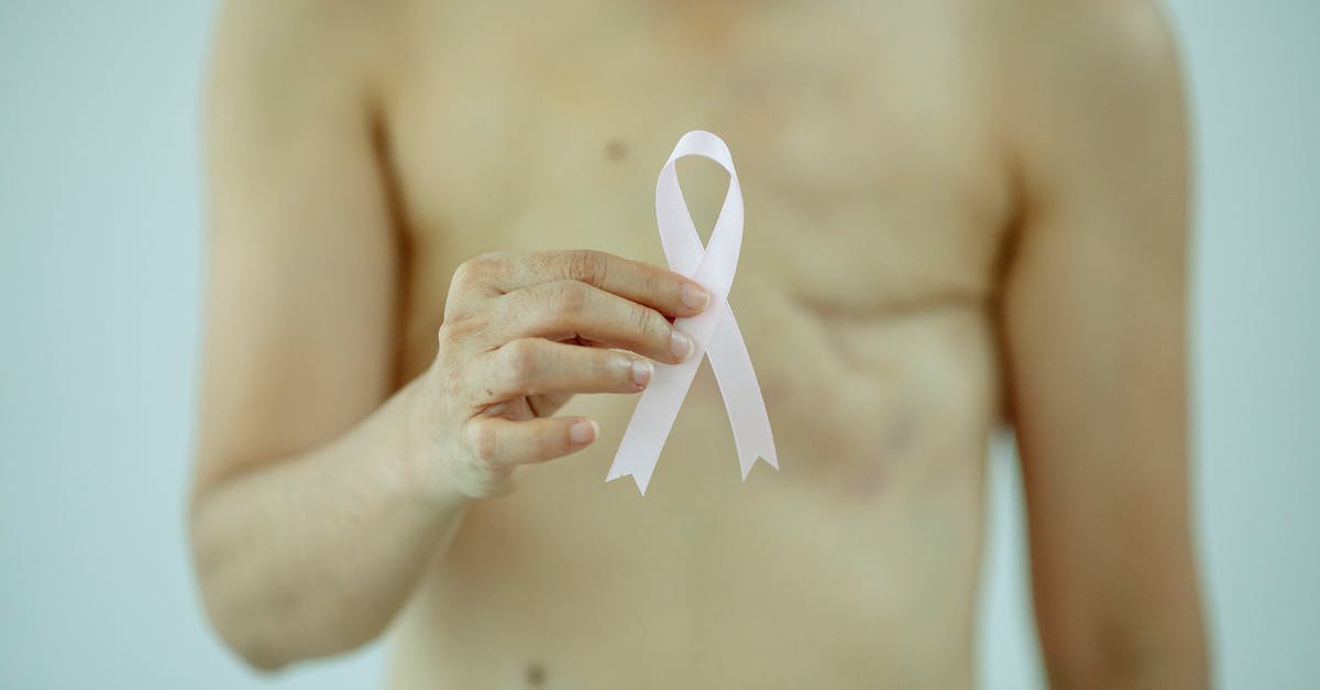 Incheon International Airport: Problem with immigration stamp - Crop anonymous female with breast cancer showing ribbon on white background of studio Incheon International Airport: Problem with immigration stamp - Crop anonymous female with breast cancer showing ribbon on white background of studio