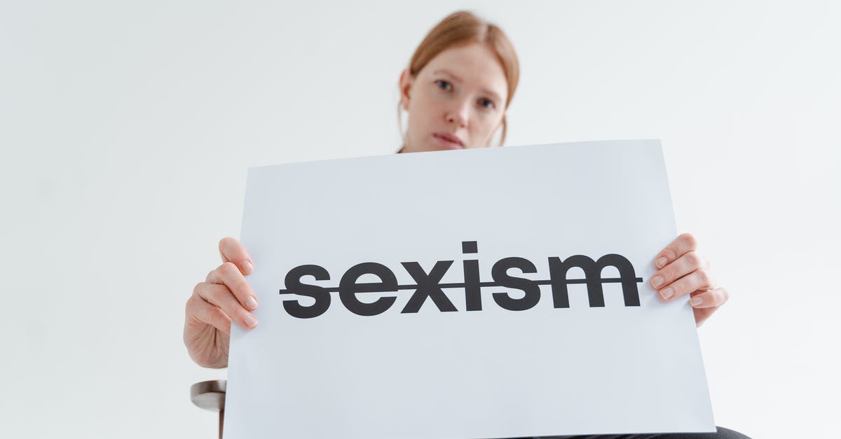 Independent contracting around the world - Woman Holding a Card with the Word Sexism Independent contracting around the world - Woman Holding a Card with the Word Sexism