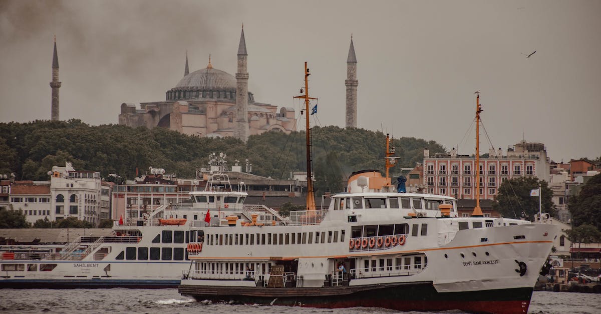 Independent excursions on Panama Canal cruise - Various vessels floating on Bosporus near ancient buildings and famous Church of Hagia Sophia against cloudy sky Independent excursions on Panama Canal cruise - Various vessels floating on Bosporus near ancient buildings and famous Church of Hagia Sophia against cloudy sky