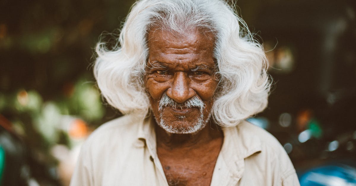 Indian citizen travelling to Belize - Optimist elderly ethnic man on urban street Indian citizen travelling to Belize - Optimist elderly ethnic man on urban street