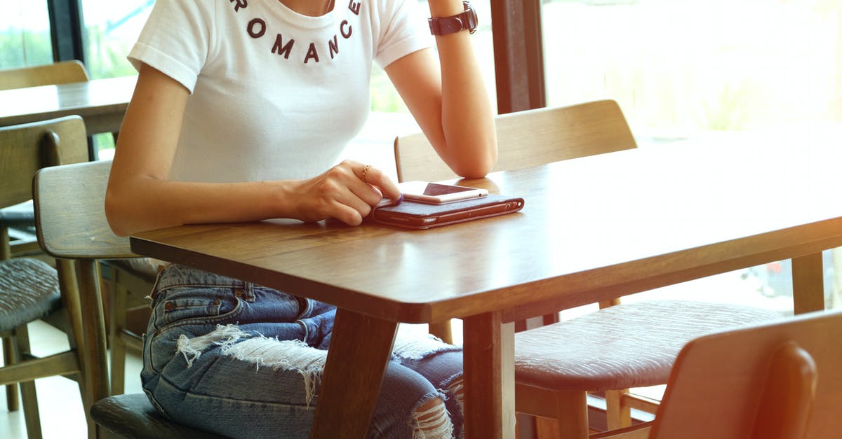 Indian customs rules on bringing packed iPhone [duplicate] - Woman Sits on Chair Front of Table