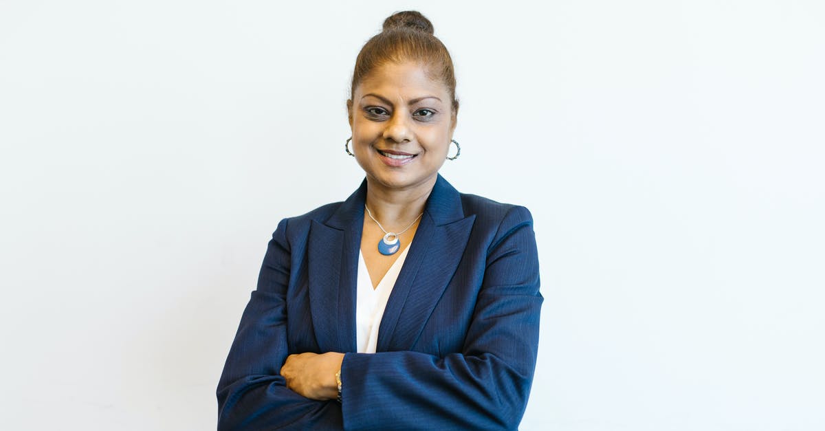 Indian e-visa: where is the immigration office located on Delhi airport? - Woman in Blue Blazer Smiling