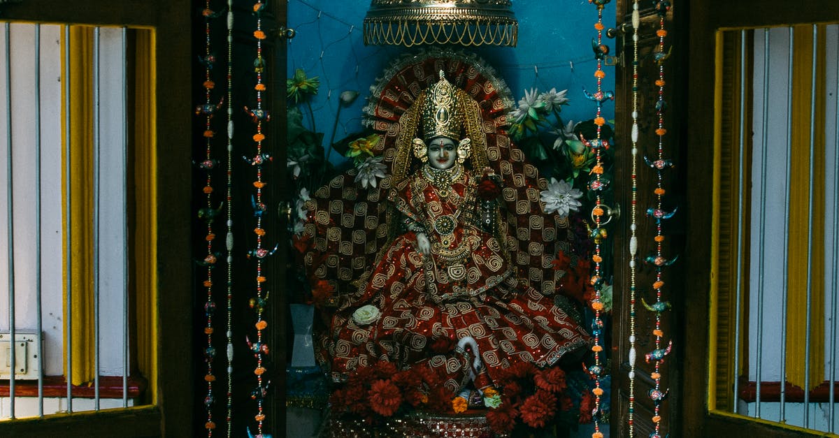Indian National travelling to Dublin with a UK Visa - Colourful statue of Indian traditional god sculpture on throne with bright clothes decorated with flowers in traditional oriental altar for home prays and meditations Indian National travelling to Dublin with a UK Visa - Colourful statue of Indian traditional god sculpture on throne with bright clothes decorated with flowers in traditional oriental altar for home prays and meditations