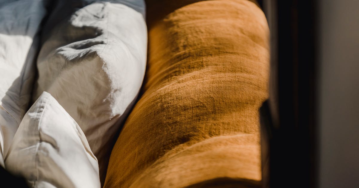 Indian Passport back cover torn a bit. Can it get accepted? [duplicate] - Soft cozy back of brown couch and cushions in white cotton sheets under sunshine from window