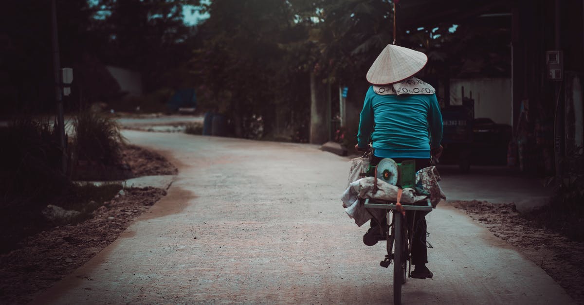Indian travelling by road through Cambodia, Laos and Vietnam - Person Riding a Bicycle Cycling on Road Indian travelling by road through Cambodia, Laos and Vietnam - Person Riding a Bicycle Cycling on Road
