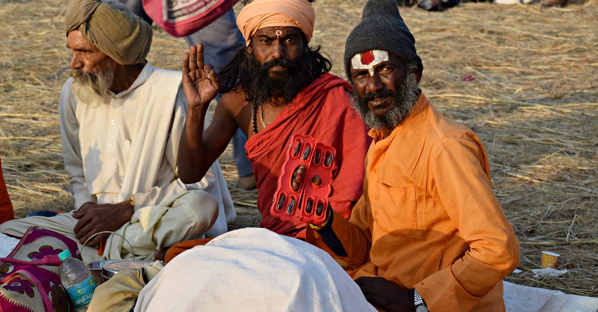 Indian visa re-entry and cancellation - Man in Orange Crew Neck T-shirt Sitting Beside Woman in White Dress Indian visa re-entry and cancellation - Man in Orange Crew Neck T-shirt Sitting Beside Woman in White Dress