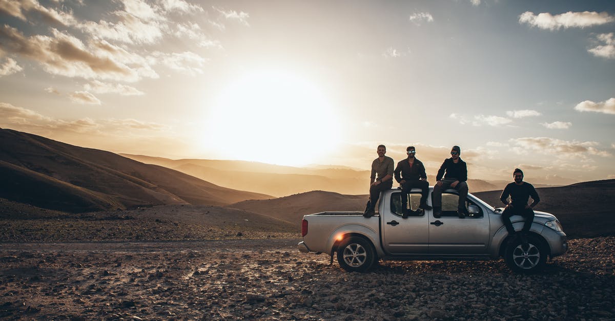 Insurance claim for cancelled trip due to sickness - Men Sitting on a Pickup Truck on a Road in Mountains Insurance claim for cancelled trip due to sickness - Men Sitting on a Pickup Truck on a Road in Mountains
