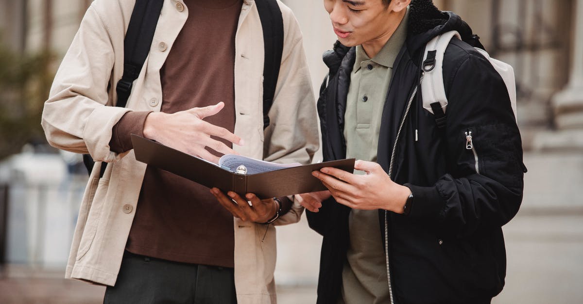 Intended day of arrival after course start date - UK Tier 4 General Student [closed] - Asian student discussing project with classmate