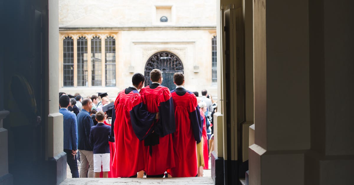 International student in Europe, travel to US and back to EU, is that possible? [closed] - Faceless men in red cloaks standing on crowded square