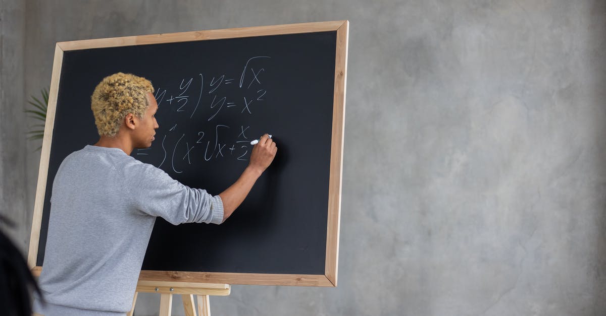 International Student With a UK Visa Question - Serious black student writing mathematical example on blackboard International Student With a UK Visa Question - Serious black student writing mathematical example on blackboard