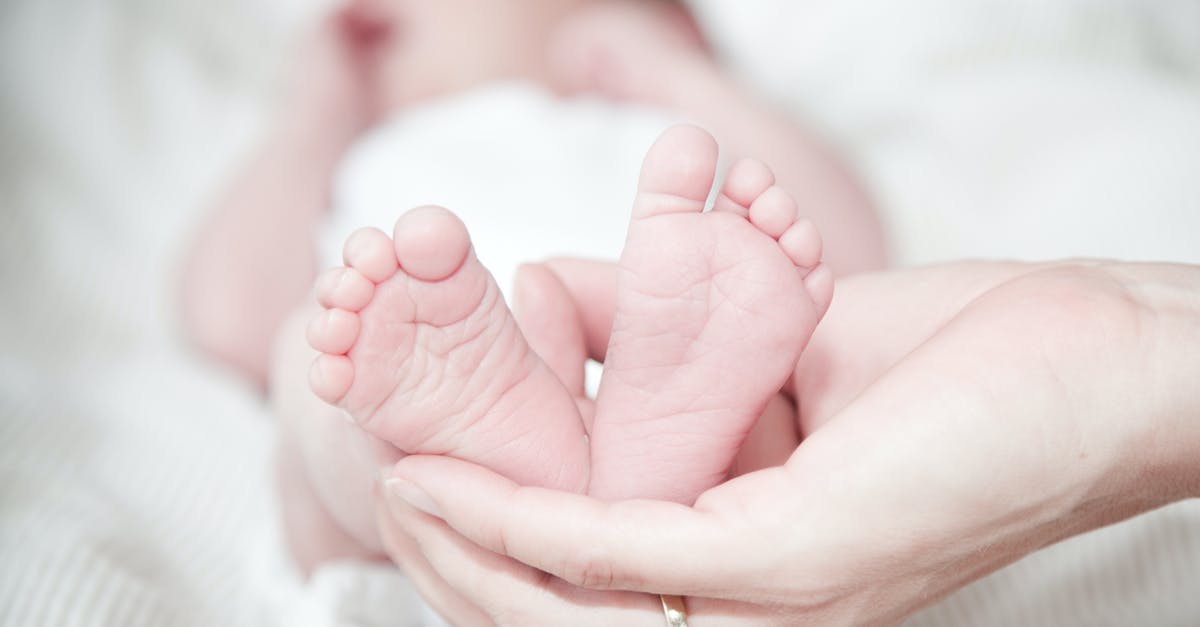 Is a birth certificate enough for a Nexus child application? - Close-up of Hands Holding Baby Feet Is a birth certificate enough for a Nexus child application? - Close-up of Hands Holding Baby Feet