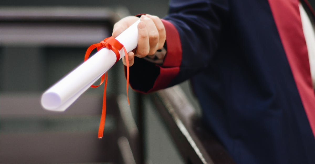 Is a college degree needed to get a tourist visa? - Person Holding White Scroll Is a college degree needed to get a tourist visa? - Person Holding White Scroll