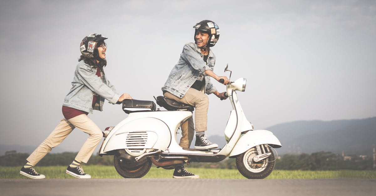 Is a driving licence needed to drive a scooter in Ibiza? - Woman Pushing A Scooter Is a driving licence needed to drive a scooter in Ibiza? - Woman Pushing A Scooter
