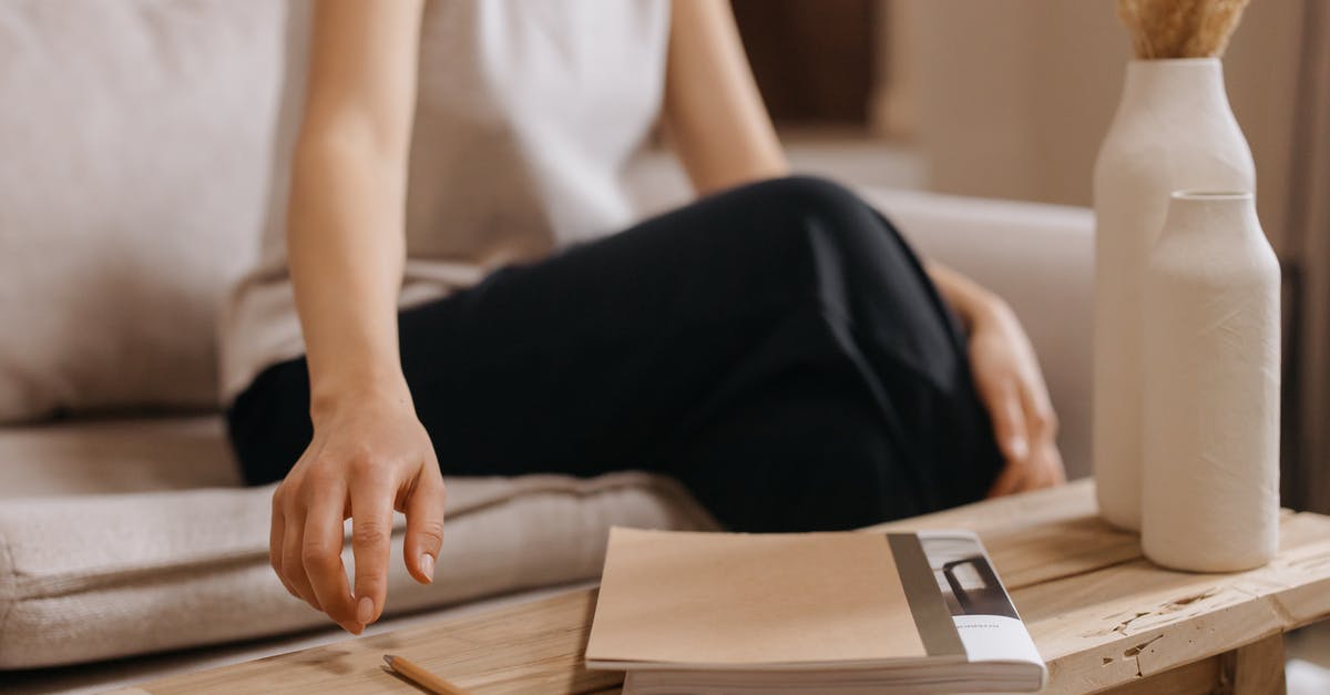 Is a visa needed for layover or getting to the connecting flight? [duplicate] - Woman in White Shirt and Black Pants Sitting on Chair Reading Book