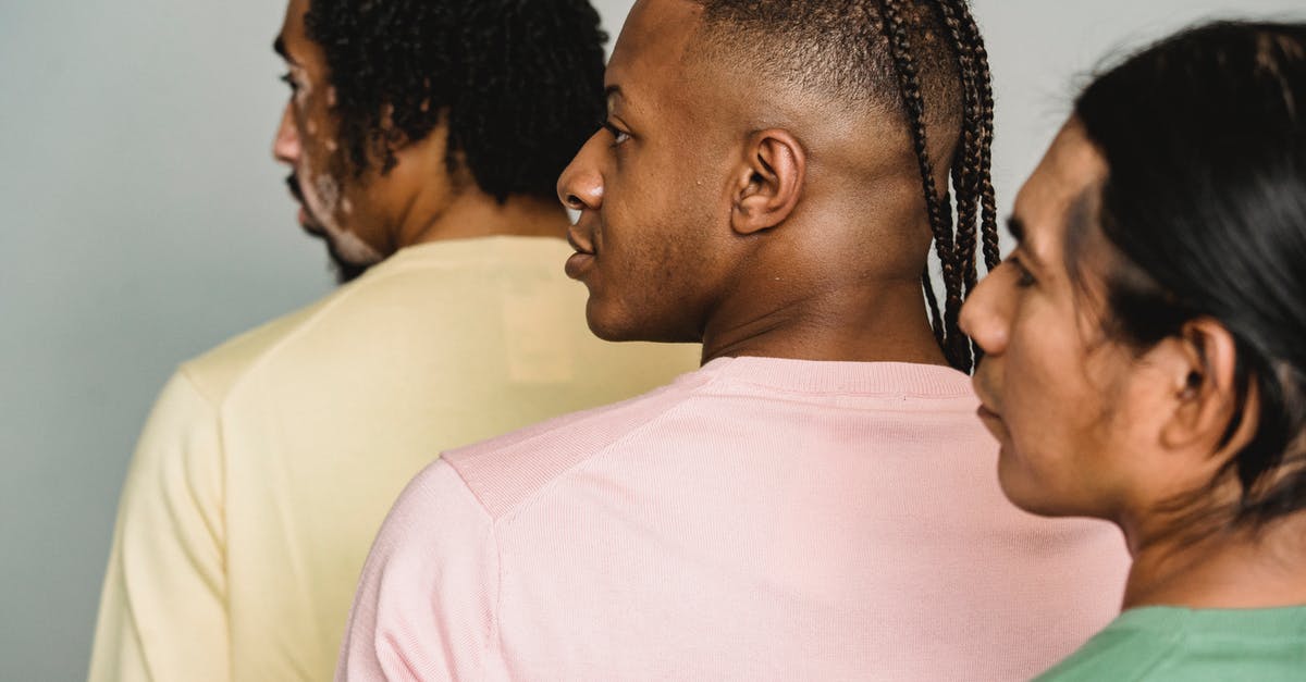 Is American Express widely accepted in UK? - Multiethnic crop men standing in studio Is American Express widely accepted in UK? - Multiethnic crop men standing in studio