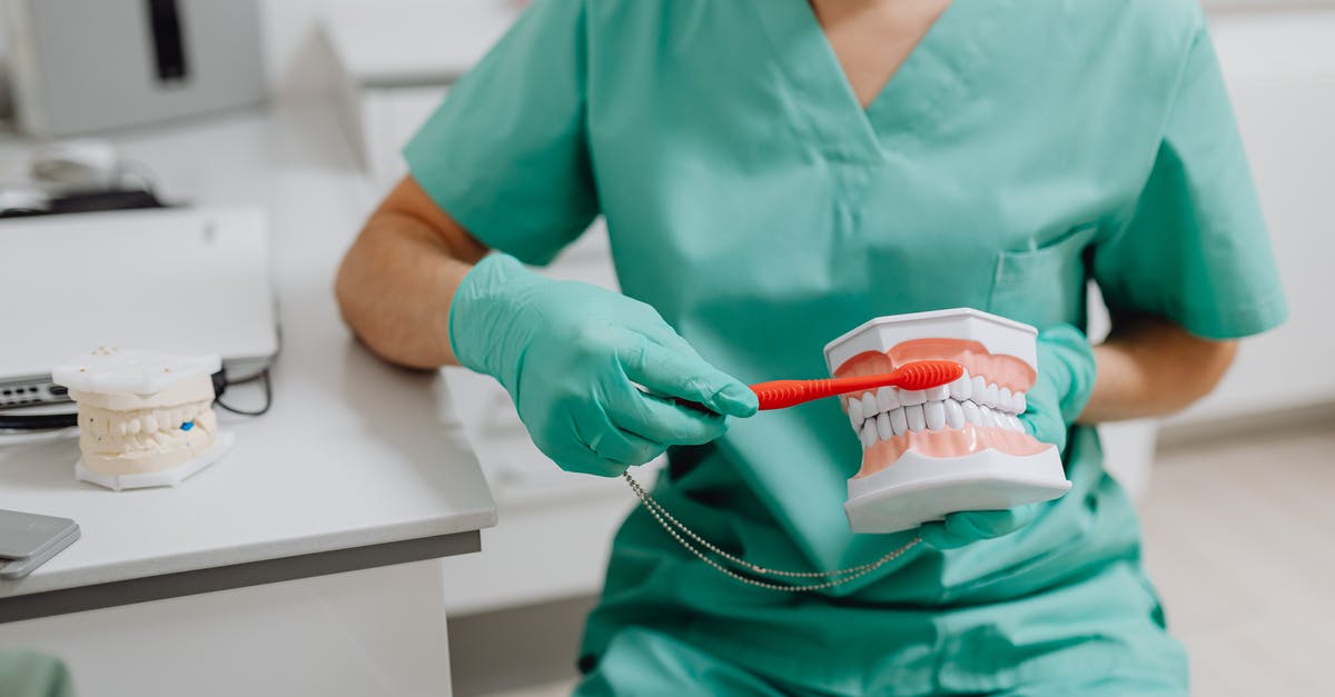 Is brushing your teeth in the public toilet a culture specific activity? [closed] - Photo of a Dentist Demonstrating How to Brush Teeth