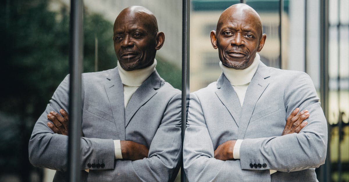 Is busticket4.me reliable? - Serious black businessman leaning on glass wall Is busticket4.me reliable? - Serious black businessman leaning on glass wall
